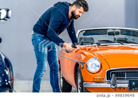 Professional detailing, polish, wash and cleaning car with microfiber in garage Professional detailing, polish, wash and cleaning car with microfiber in garage 99839649