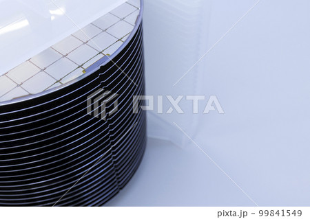 Silicon wafer inspection. A batch of silicon wafers packed in a plastic storage box in the clean room of a semiconductor foundry ready for microchip production. 99841549
