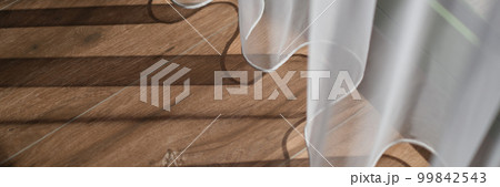 Shadow from white curtains on wooden floor background Shadow from white curtains on wooden floor background 99842543