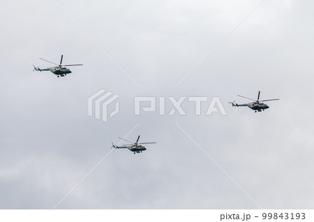Group of three Mi-17 military Russian helicopters fliy in cloudy sky Group of three Mi-17 military Russian helicopters fliy in cloudy sky 99843193