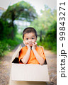 Asian children playing in cardboard boxes 99843271