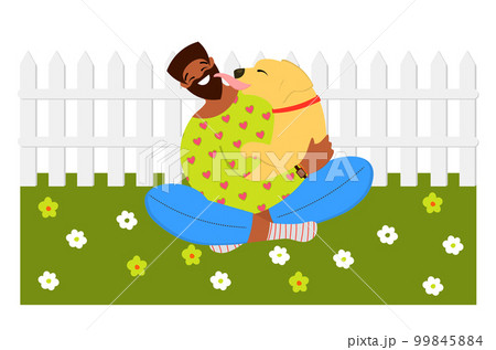 African American Man cuddling with a dog on the lawn. Month of pets. Friendship with a dog. 99845884