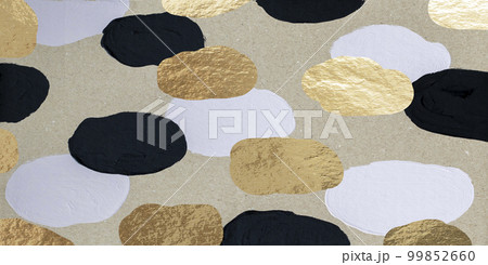 Simple abstract design on cardboard with black and white paint stains and gold circles. 99852660