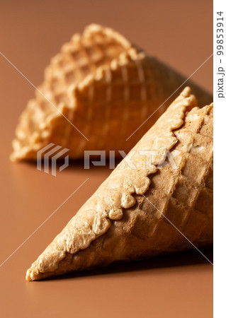 Close-up of waffle cones, creative macro concept of sweets and food. 99853914
