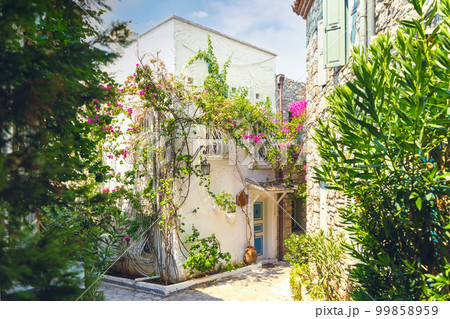 Narrow street in old town of Marmaris, Turkey . Beautiful scenic old ancient white houses with flowers. Narrow street in old town of Marmaris, Turkey . Beautiful scenic old ancient white houses with flowers. 99858959