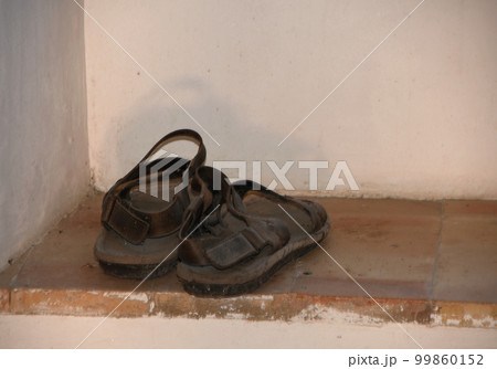 The old monk sandals in a window 99860152