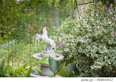 White horse monument decorated on small fountain in park 99860932