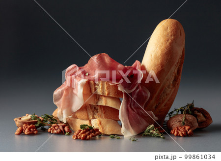 Prosciutto with baguette, walnuts, and thyme. 99861034