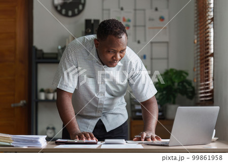 American African Businessman research and analysis with financial graph at office. Strategy, chart, finance report concept 99861958