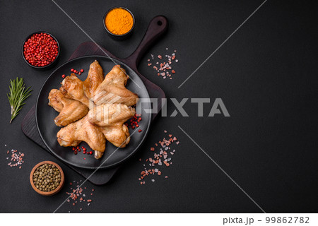 Baked chicken wings with salt, spices and herbs Baked chicken wings with salt, spices and herbs 99862782