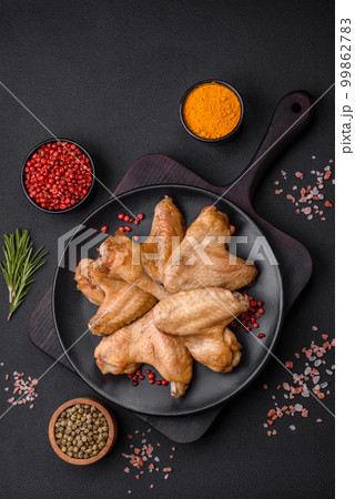 Baked chicken wings with salt, spices and herbs 99862783