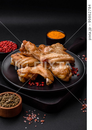 Baked chicken wings with salt, spices and herbs Baked chicken wings with salt, spices and herbs 99862784