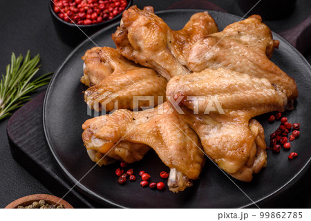 Baked chicken wings with salt, spices and herbs 99862785