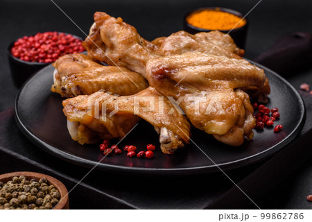 Baked chicken wings with salt, spices and herbs Baked chicken wings with salt, spices and herbs 99862786
