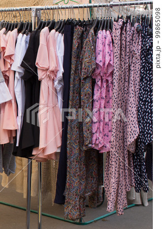 Clothing on a hanger, Bright women's clothing.Clothes at the fair. Clothes on a hanger, Bright women's clothes. Clothes at the fair. vertical photo Clothing on a hanger, Bright women's clothing.Clothes at the fair. Clothes on a hanger, Bright women's clothes. Clothes at the fair. vertical photo 99865098