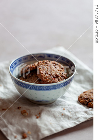 Homemade cookies with cereal and seeds, bowl on a table 99873721