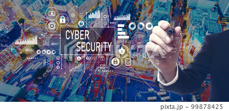 Cyber security theme with businessman in city at night Cyber security theme with businessman in city at night 99878425