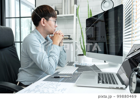 Male programmer is programing to developing program app and website of corporate while working to checking program code and debugging on multiple screen at modern software office Male programmer is programing to developing program app and website of corporate while working to checking program code and debugging on multiple screen at modern software office 99880469