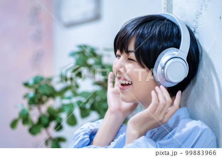 ヘッドフォンで音楽を聴く女性 99883966
