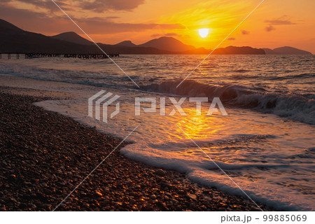 Closeup sea beach and orange sunrise sky calmness 99885069