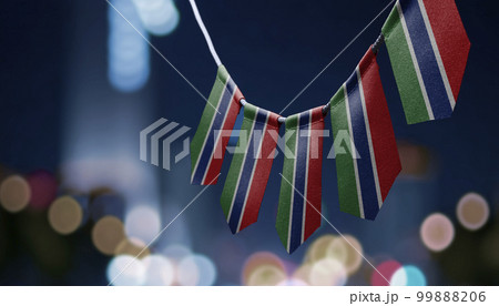 A garland of Gambia national flags on an abstract blurred background 99888206