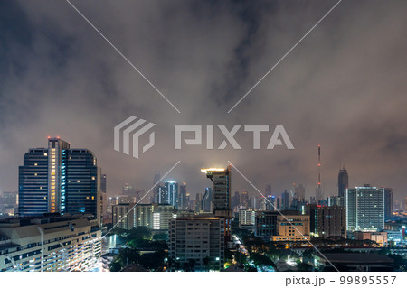 View of Bangkok high-rises at night with moving clouds in the sky View of Bangkok high-rises at night with moving clouds in the sky 99895557