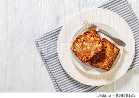 apple cinnamon bread on white plate, top view 99898135