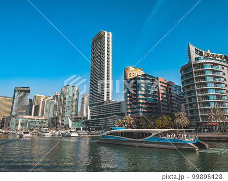 Dubai Marina, harbour, cruise boat and canal promenade view at sunset, in Dubai, United Arab Dubai Marina, harbour, cruise boat and canal promenade view at sunset, in Dubai, United Arab 99898428