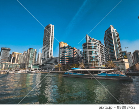 Dubai Marina, harbour, cruise boat and canal promenade view at sunset, in Dubai, United Arab 99898452