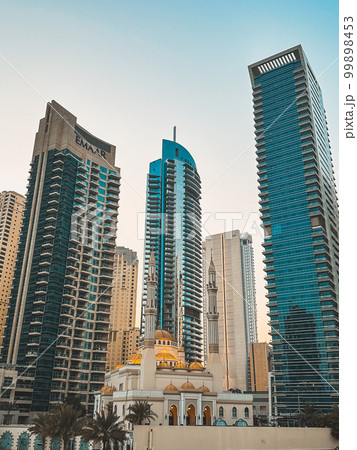 Dubai Marina Mosque, harbour, cruise boat and canal promenade view at sunset, in Dubai, United Arab Dubai Marina Mosque, harbour, cruise boat and canal promenade view at sunset, in Dubai, United Arab 99898453