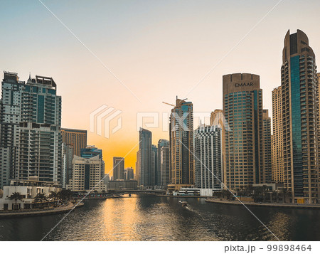 Dubai Marina, harbour, cruise boat and canal promenade view at sunset, in Dubai, United Arab Dubai Marina, harbour, cruise boat and canal promenade view at sunset, in Dubai, United Arab 99898464
