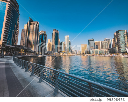 Dubai Marina, harbour, cruise boat and canal promenade view at sunset, in Dubai, United Arab Dubai Marina, harbour, cruise boat and canal promenade view at sunset, in Dubai, United Arab 99898478