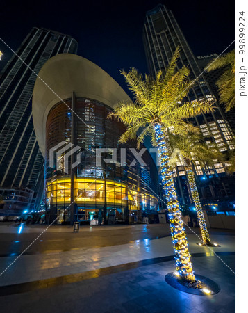 Dubai Opera house by night in Downtown Dubai, surrounded by skyscrapers and Burj Khalifa, in UAE 99899224