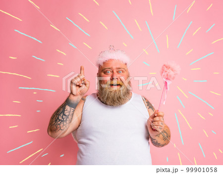 Fat man with tattoos and beard acts like a magic fairy 99901058