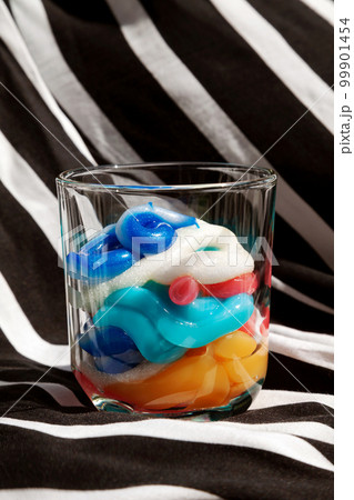 Various toothpaste of many colors squeezed into a glass. Delicious colorful toothpaste as a dessert concept 99901454