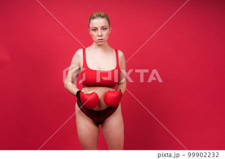 A beautiful, attractive, seductive girl with blonde hair in the studio. A beautiful, attractive, seductive girl with blonde hair in the studio. 99902232