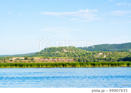 Train on the railway on the bank of the river Sok in the village of Malaya Tsarevschina Samara region Russia 99907635