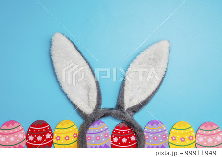 Colorful painted Easter eggs with bunny ears on blue background Colorful painted Easter eggs with bunny ears on blue background 99911949