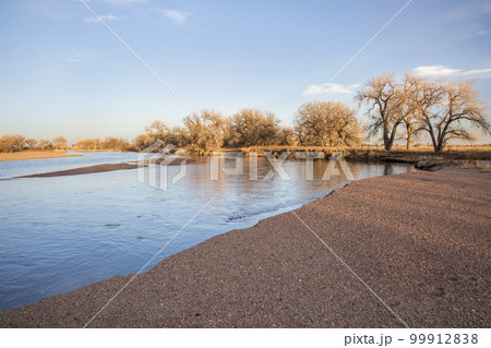 winter sunset over South Platte River and gravel bar in eastern Colorado winter sunset over South Platte River and gravel bar in eastern Colorado 99912838