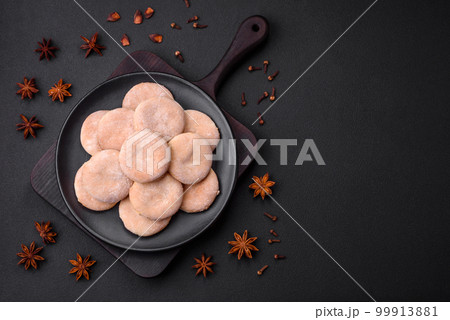 Delicious fresh baked cornmeal shortcakes or cookies on a black plate Delicious fresh baked cornmeal shortcakes or cookies on a black plate 99913881