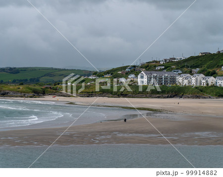 A hotel on the Atlantic Ocean. Inchydoney beach at low tide. Landscape. White concrete building near body of water. Inchydoney Island 99914882