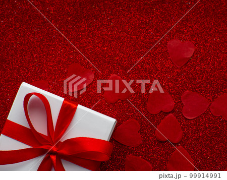 White gift box is on red heart paper background, top view 99914991