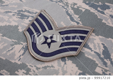 August 31, 2020. US AIR FORCE Staff Sergeant rank patch on digital tiger-stripe pattern Airman Battle Uniform (ABU) background 99917210