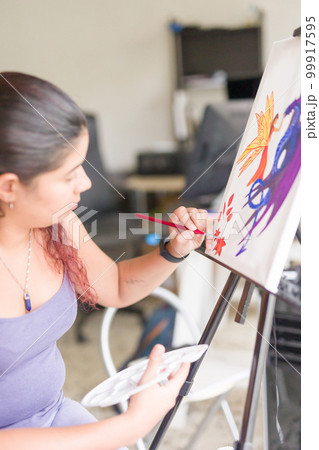 Painting artwork leisure at home. Enjoy weekend hobby. South american venezuelan mid woman close-up 99917595