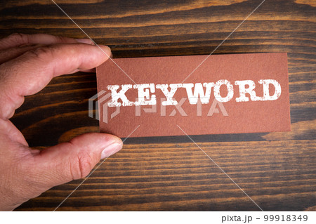 KEYWORD. Text on brown paper. Wood texture background KEYWORD. Text on brown paper. Wood texture background 99918349