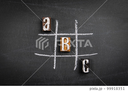Letters of the alphabet and game of tic tac on a chalk board Letters of the alphabet and game of tic tac on a chalk board 99918351