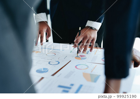 business group people are meeting and discussing budget and marketing plans in order to strategize to win over partners in order to keep the company number one. 99925190