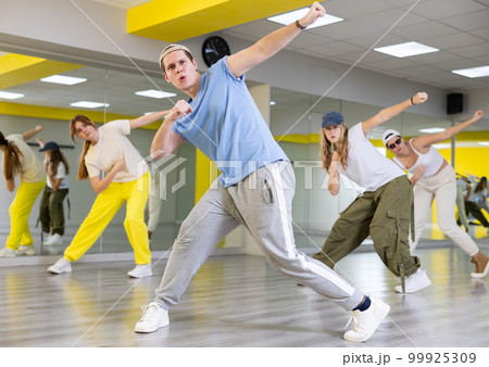 Young guy dancing modern dance in studio Young guy dancing modern dance in studio 99925309