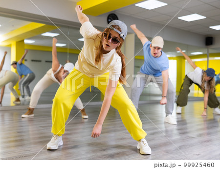 Teen girl in cap dances hip hop dances Teen girl in cap dances hip hop dances 99925460