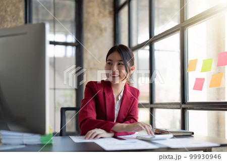 businesswoman working on desk office with using a calculator to calculate the numbers, finance accounting concept businesswoman working on desk office with using a calculator to calculate the numbers, finance accounting concept 99930946